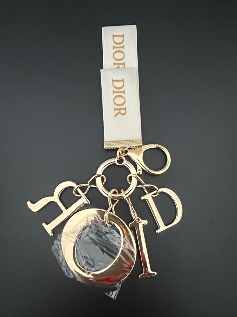 Dior Gold Letter Charm Keyring with White Logo Strap Bag Charm in Box.